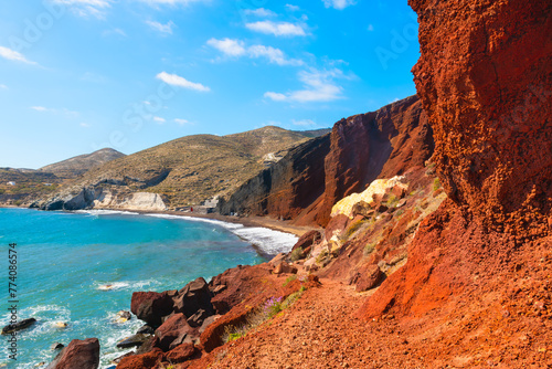 Red beach in Santorini island, Greece. Red volcanic cliffs and the blue sea.