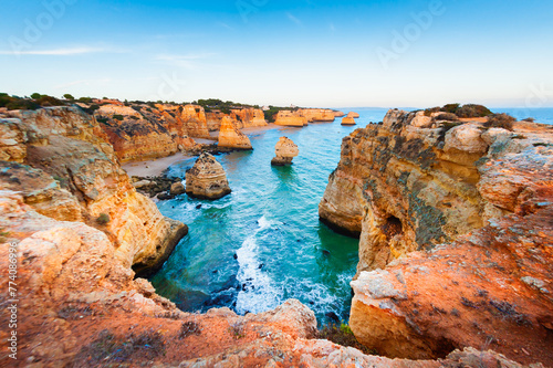 Rocks on the shore of Atlantic ocean in Algarve, Portugal. Summer seascape at sunset. © smallredgirl