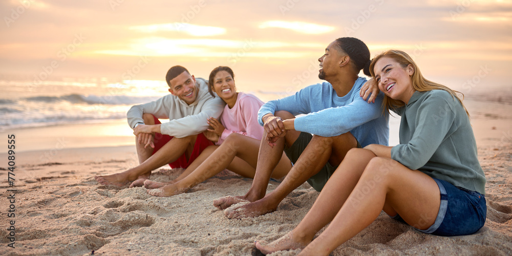 Young Couple With Friends In Casual Clothing On Vacation Sitting On Beach Watching Sunrise Together Young Couple With Friends In Casual Clothing On Vacation Sitting On Beach Watching Sunrise Together