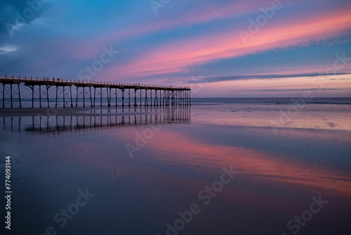 Beautiful scenery of the Saltburn beach's pier at sunrise