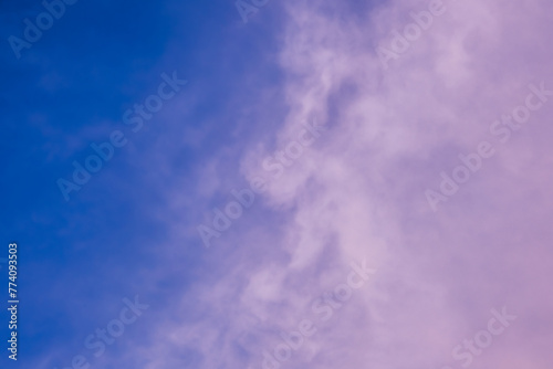 The sky at dusk was a breathtaking sight, with electric blue hues blending into shades of purple clouds. A few cumulus clouds hovered above the horizon, creating a stunning meteorological phenomenon