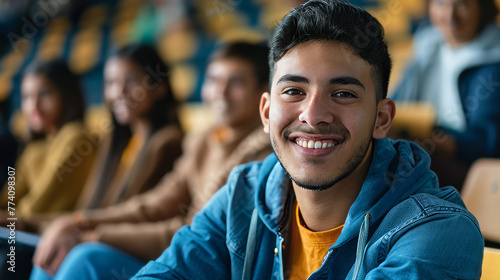 Portrait of a latino american happy university student sitting in a college lecture hall photo