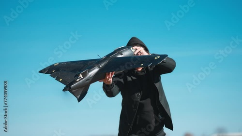man launches drone during spring in blue sky. Ukrainian military uses a aircraft plane drone to detect enemy positions. The concept of using modern technologies in the army.