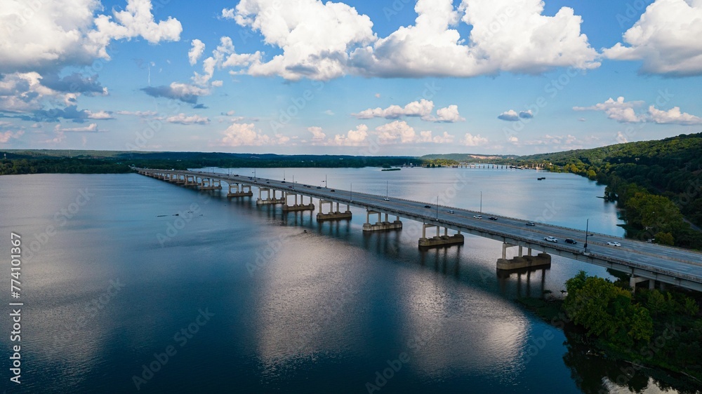 Beautiful drone view of seascape with bridge over a river in Canada under blue cloudy sky