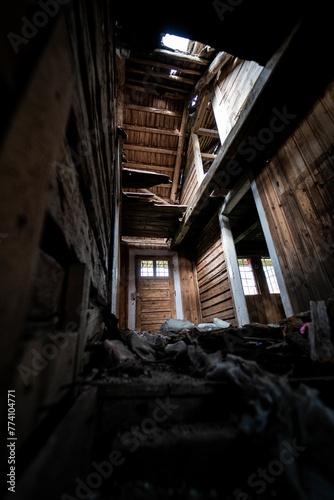 Vertical shot of an interior of an abandoned wooden house