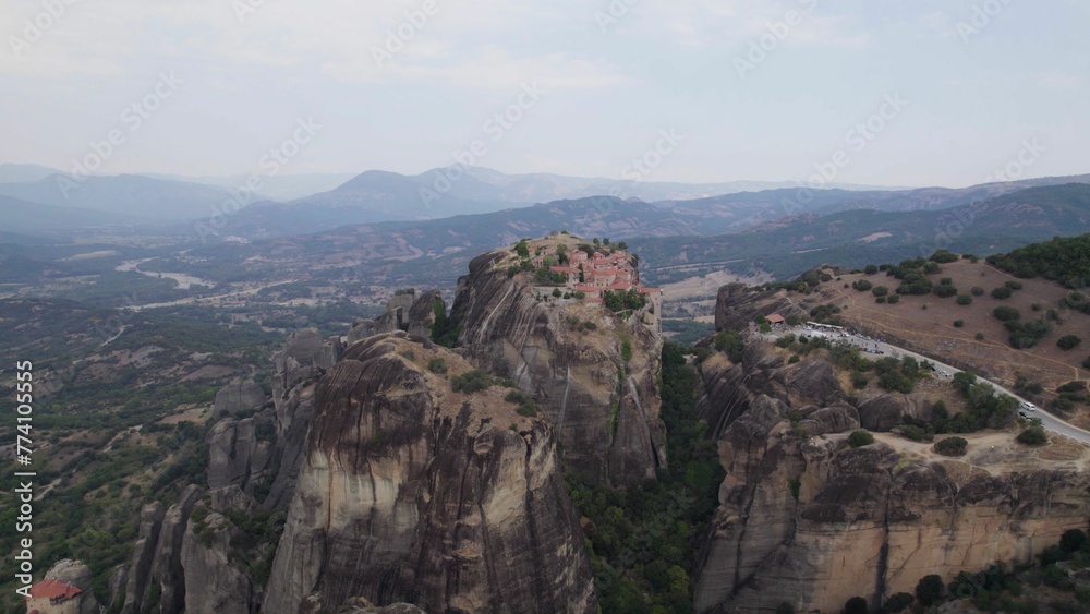 Aerial view of Meteora rock formations surrounded by buildings