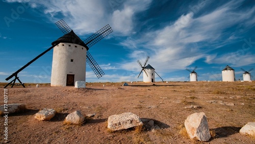 Line of Windmills of Campo de Criptana village in La Mancha region, Spain with blue sky photo