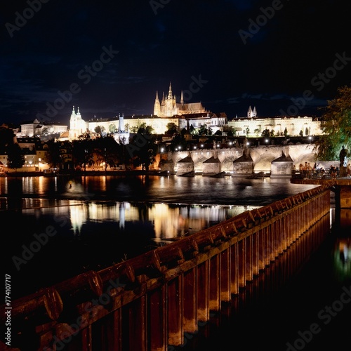 Beautiful scenery of illuminated Prague Castle at night reflected on the Vltava river