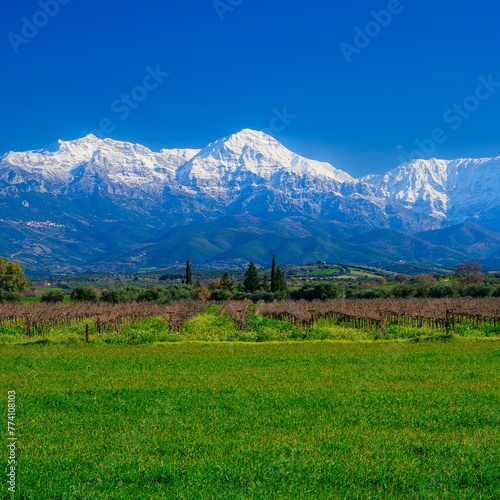 Erymanthos mountain range covered in snow during sunny winter day photo