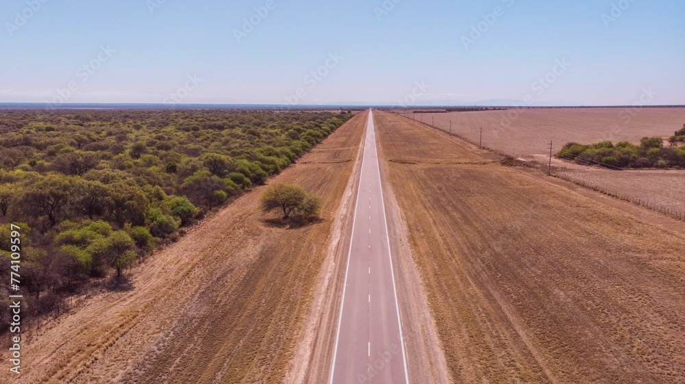 Aerial view of a highway road in the middle of the field