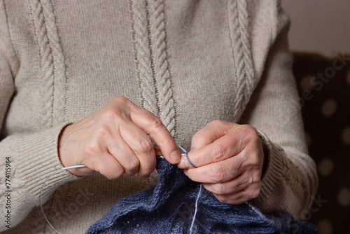 Woman knitting at home, close-up