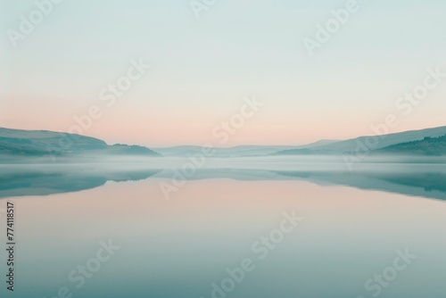 Misty Morning Serenity with Calm Waters and Pastel Sunrise