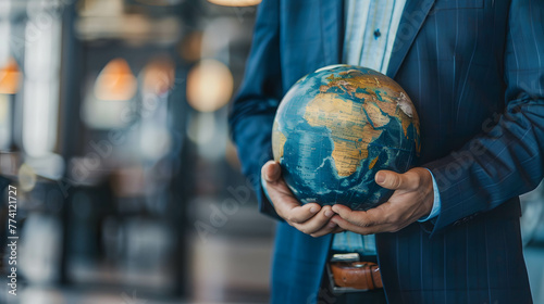A businessman and a globe while analyzing investment opportunities, investment diversification strategies, portfolio management and asset allocation