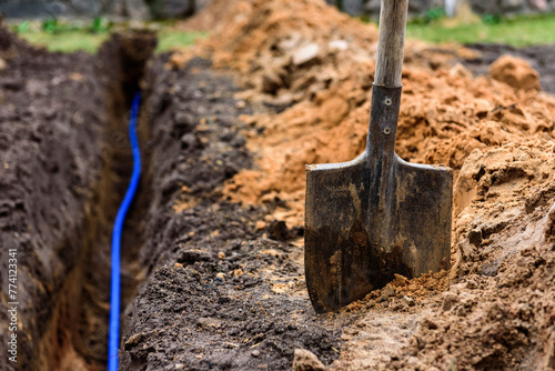 Earth trench dug to lay pipe or optical fiber.