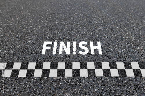 Finish line racing background top view, Textured asphalt with finishing line.