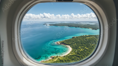 The view through an airplane window reveals a stunning tropical coastline with clear turquoise waters, lush greenery, and a bright sandy beach © Kevin