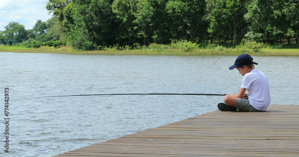 Small boy fishing alone at lake Small boy fishing alone at lake
