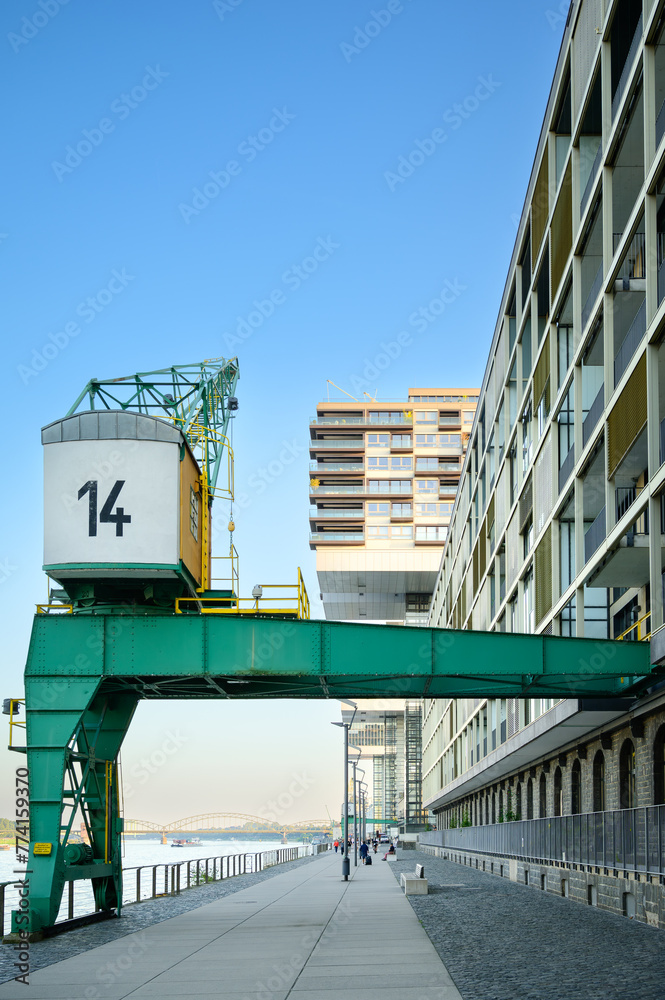Promenade at the Rhine Harbor in Cologne, Germany: Modern apartment and office buildings line the formal industrial harbor