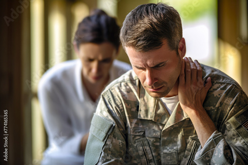 Pained Caucasian male soldier, hand on neck, looks strained from headache. Doctor listens to his complaints and provides advice. Concept of medical empathy, headache, stress relief and healthcare