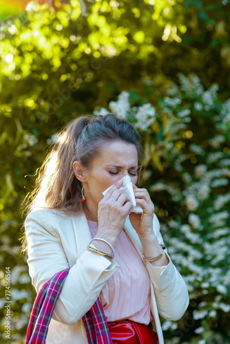 woman in dress and jacket in city has allergy attack