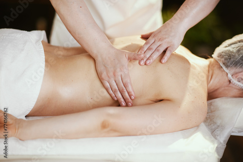 massage therapist in massage cabinet massaging client