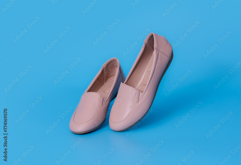 Fototapeta premium Flats shoes leather on blue background