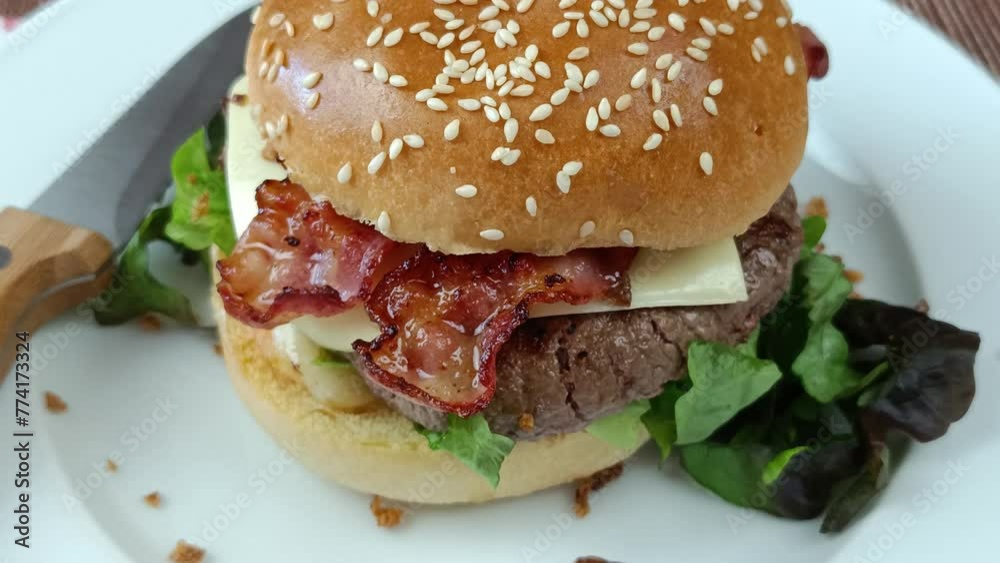 cheeseburger au bacon et boeuf, en gros plan, dans une assiette cheeseburger au bacon et boeuf, en gros plan, dans une assiette