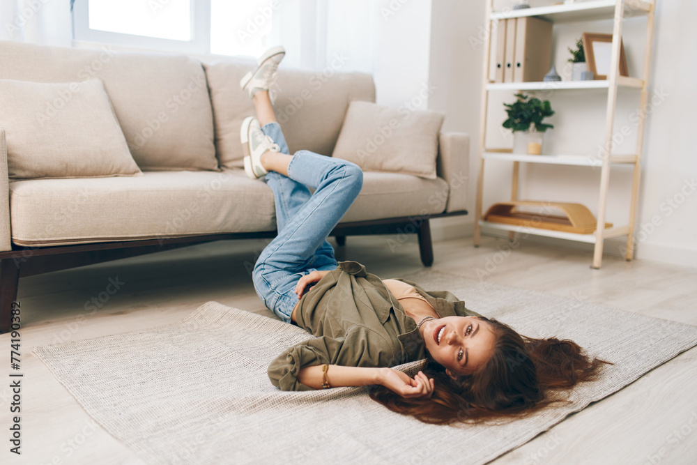 Calm and Cosy: A Happy Woman Relaxing on a Modern Sofa in a Peaceful Apartment Calm and Cosy: A Happy Woman Relaxing on a Modern Sofa in a Peaceful Apartment