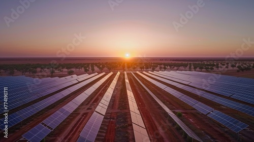 A serene dawn breaking over a vast solar farm, with rows of panels gently illuminated by the first light, their surfaces mirroring the pastel hues of the morning sky