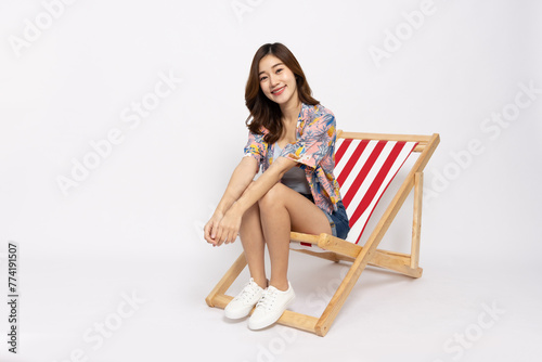 Tourists Asian woman sitting on beach chairs isolated on white background
