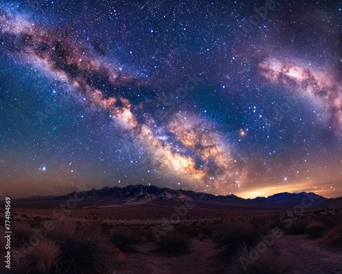 A panoramic display of the Milky Way arching over a tranquil desert landscape.