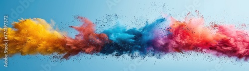 Dynamic Display: A Vibrant Color Powder Explosion Contrasting Against the Blue Sky in Holi