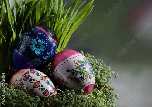 cooked and colorful Easter eggs and hen eggs as food or decoration