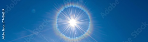 Halo around the sun in a clear blue sky photo