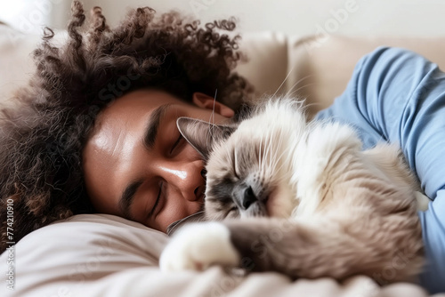 A black man sleep with with his white cat.
