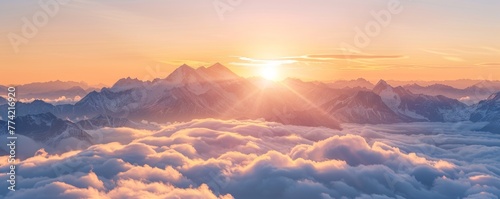 Sun-kissed peaks emerge from a sea of morning clouds