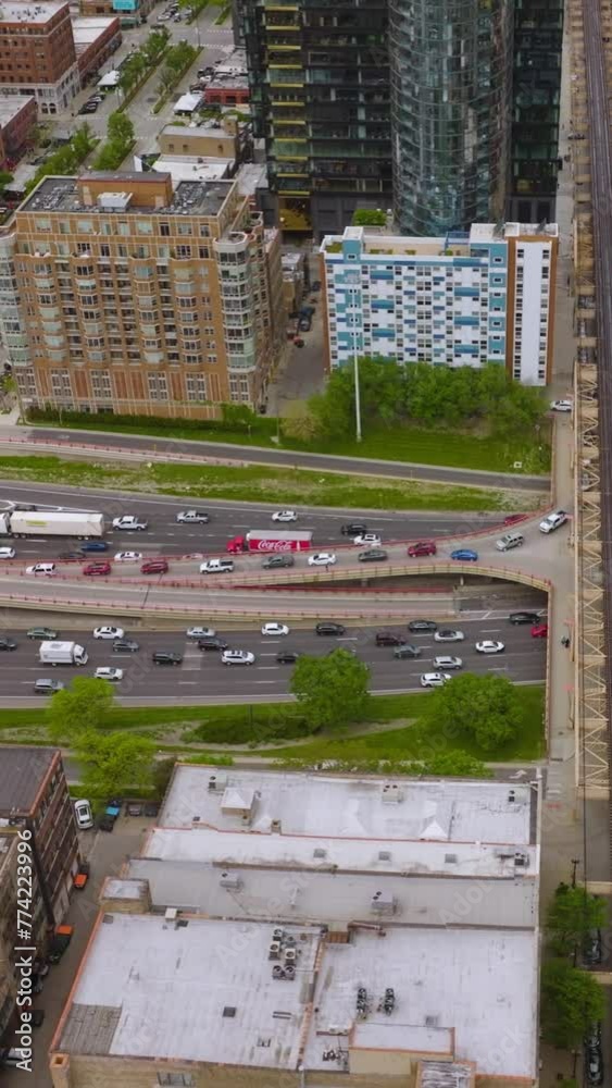 Numerous cars moving by the roads, skyways and bridges of Chicago, Illinois. Crazy traffic in modern metropolis. Top view. Vertical video