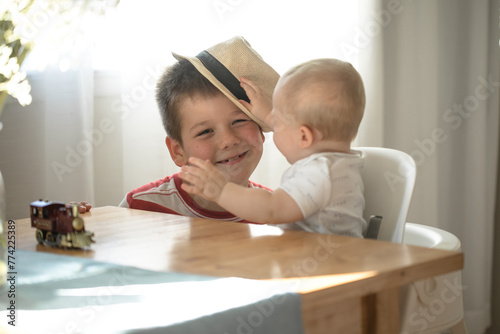 Two brothers are play togather.  Family with children at home. Love, trust and tenderness