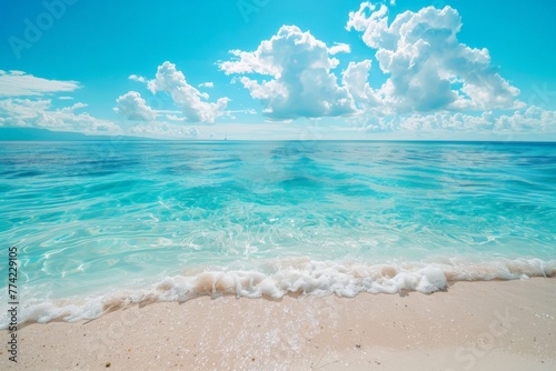 Sandy Beach With Clear Blue Water Under a Cloudy Sky