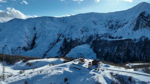 Aerial drone view of Gudauri ski resort in winter. Caucasus mountains in Georgia. Amaglebis eklesia orthodox church in Gudauri, Georgia. Gudauri Village Panorama with Ski Resort Background. photo