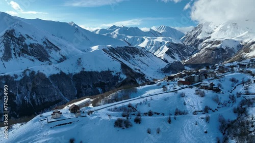 Aerial drone view of Gudauri ski resort in winter. Caucasus mountains in Georgia. Amaglebis eklesia orthodox church in Gudauri, Georgia. Gudauri Village Panorama with Ski Resort Background. photo