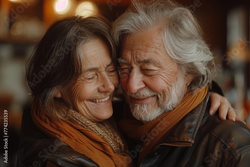 Older man and woman share an intimate cuddle, both smiling with closed eyes