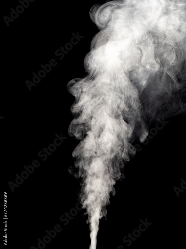 Jet of white smoke rises, streams and forms tubers isolated on a black