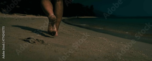 person walking on the dark beach