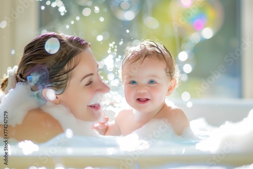 happy Mother and baby bonding, mommy and infant taking a bath in soap © Anna