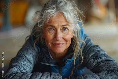 A radiant older woman with blue eyes and silver hair smiles