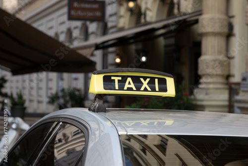 Checker taxi lighted rooftop car on a blurred background