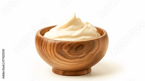 Tasty yoghurt in a wooden bowl isolated on a white background.