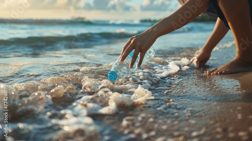 Hand woman picking up plastic bottle cleaning on the beach , volunteer concept photo