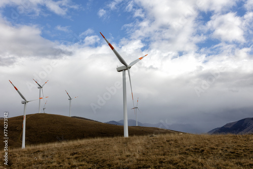 Stunning view in nature of turbines in a wind farm or wind farm located in the mountains of Italy Europe and allows for the creation of clean electricity. Sustainable and renewable for the environment